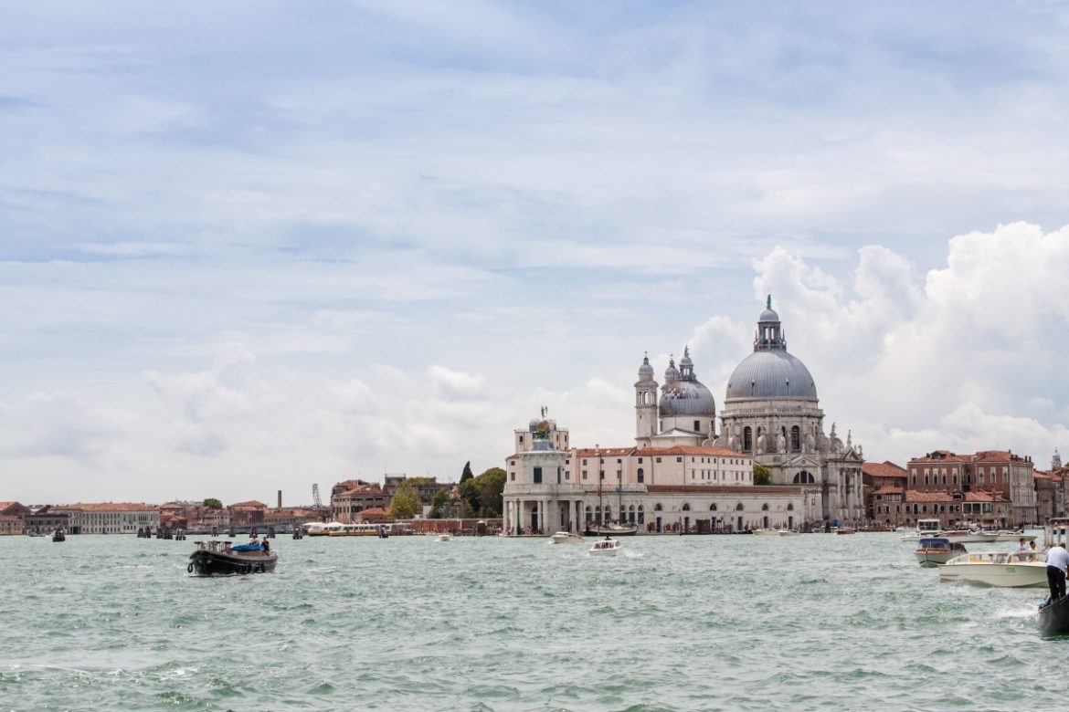 Basilica di Santa Maria della Salute seen from the Grand Canal in Venice, a highlight in any Veneto travel guide with its iconic domes rising above the water.