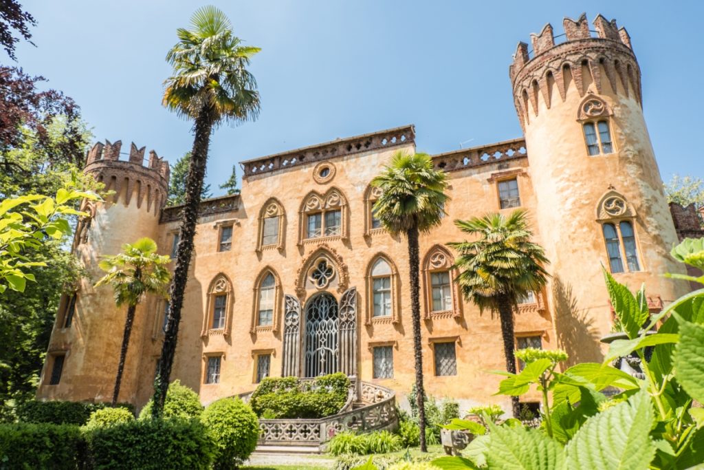 Piedmont travel highlights include contemplating the Neo-Gothic facade of Castello del Roccolo surrounded by greenery in Piedmont, Italy
