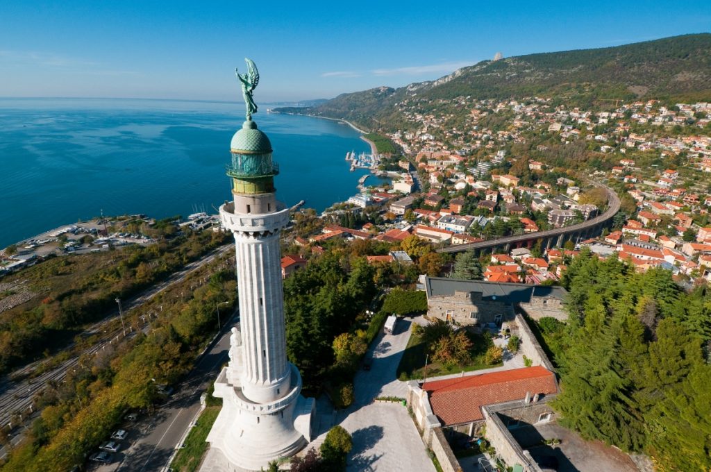 Faro della Vittoria lighthouse overlooking the Gulf of Trieste in Friuli-Venezia Giulia travel region with clear blue sky