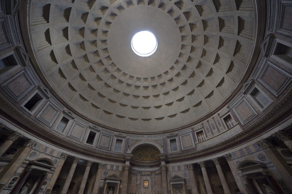 Interior view of the Pantheon dome with sunlight streaming through the central oculus onto the coffered ceiling