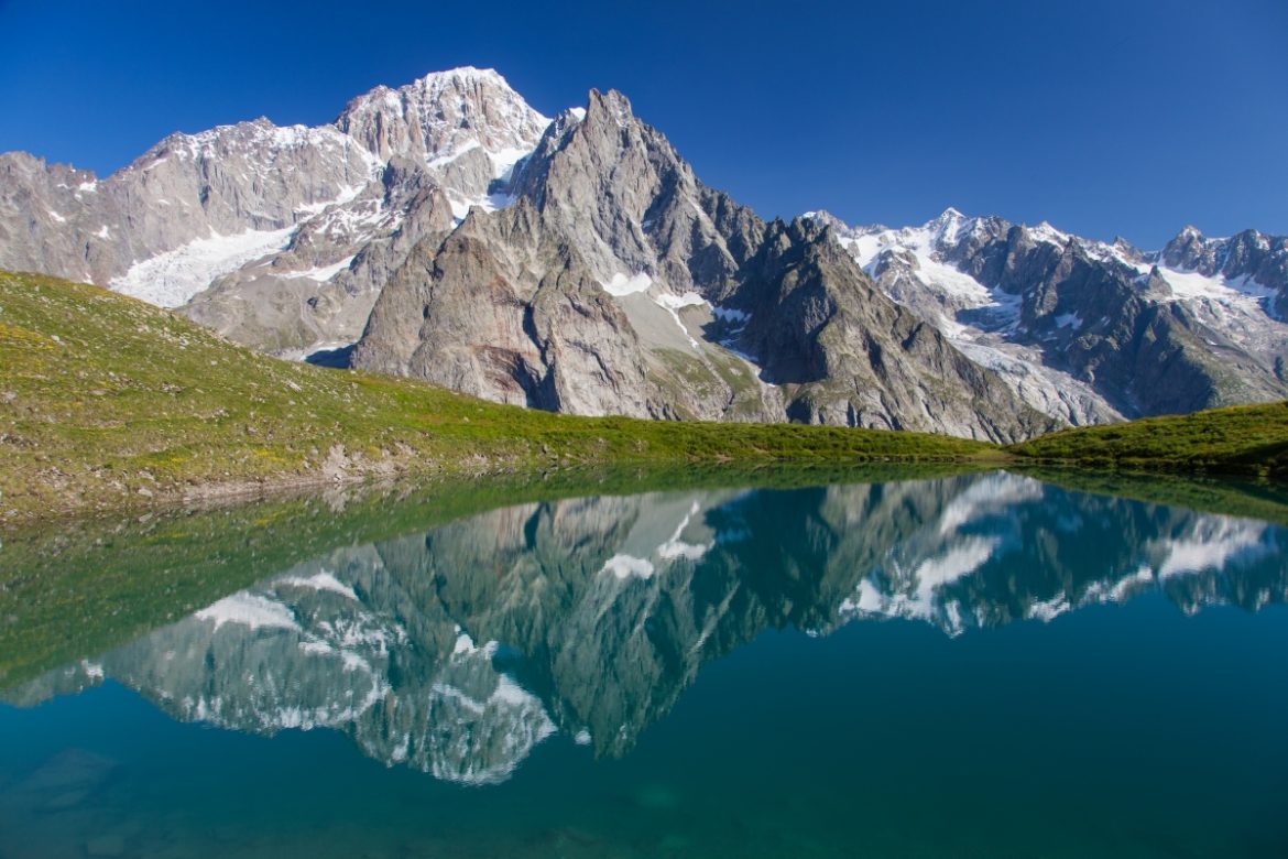 Monte Bianco rising majestically above the serene blue waters of Lago Checrouit in the Aosta Valley