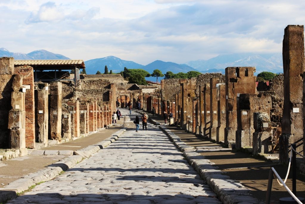 Stone streets of Pompeii with ancient villas and ruins.