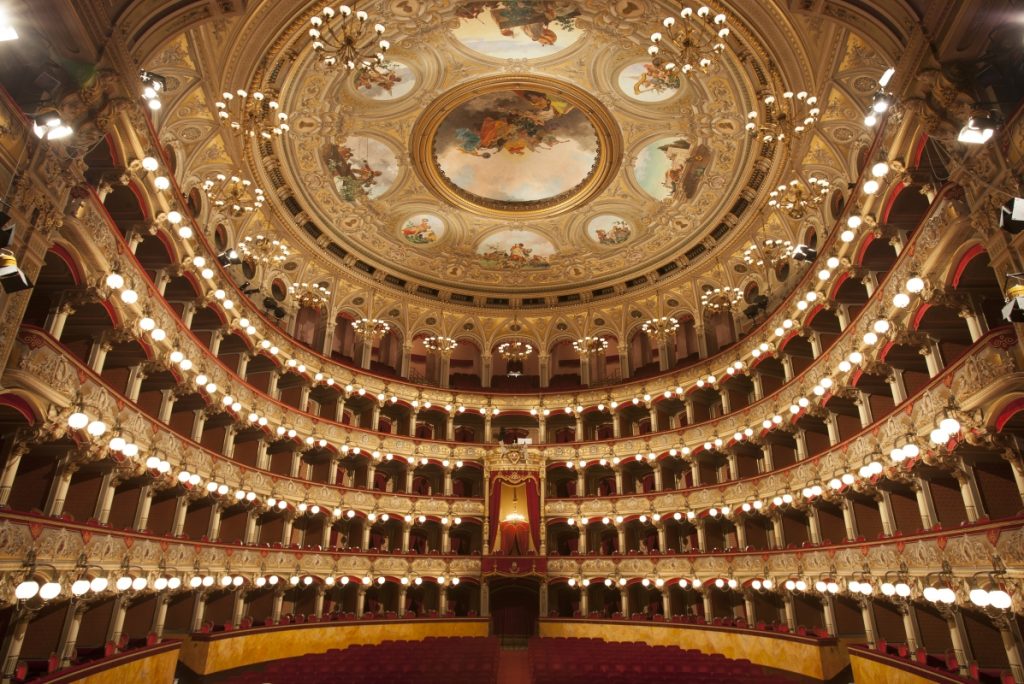 The lavish interior of Teatro Massimo Bellini with red velvet seats and gilded balconies is worth a Sicily trip