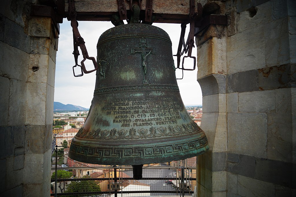 Close-up of a bell inside the Leaning Tower of Pisa, part of the iconic structure that makes people wonder why the Pisa Tower is leaning