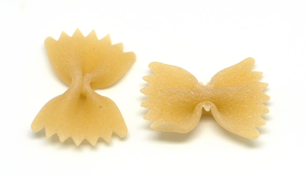 Italian pasta shapes guide: Farfalle pasta closeup on a white background