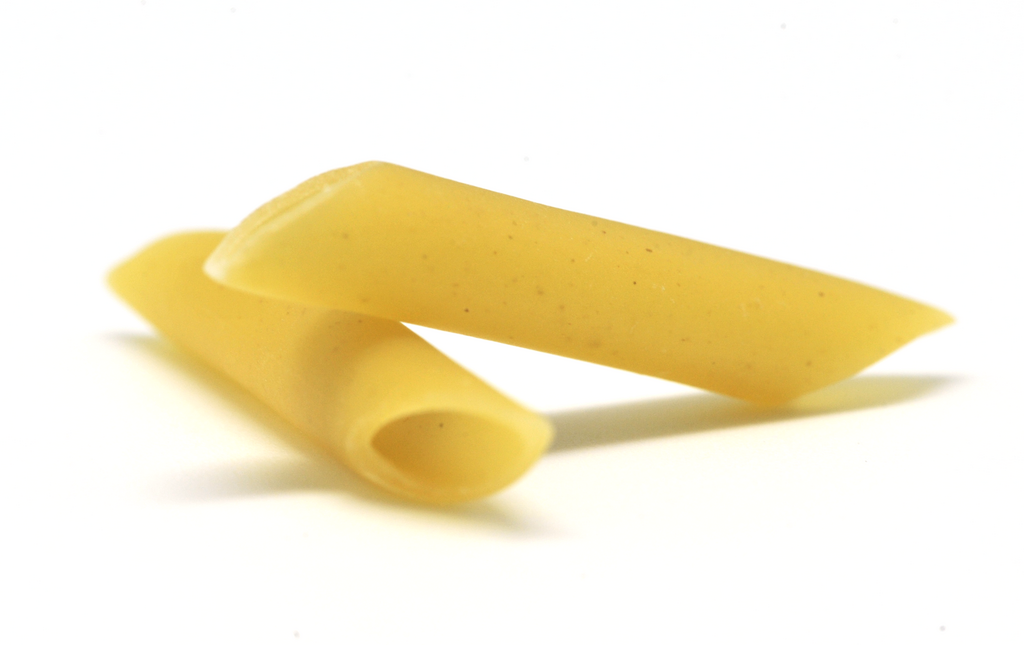 Penne pasta closeup on a white background